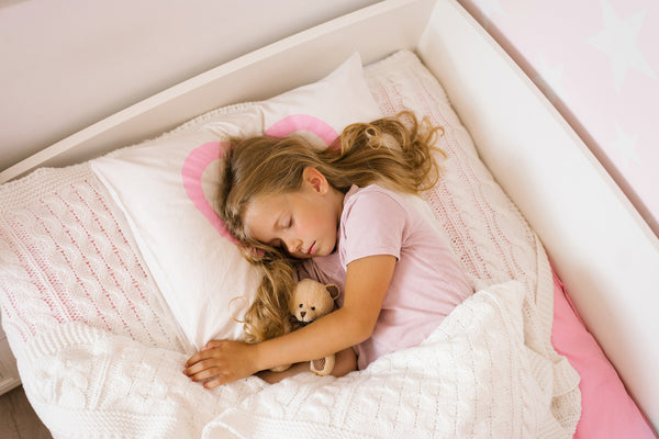 Cute girl soft toys sleeping peacefully in cozy bed